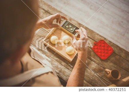 Guy taking photo of his delicious meal Guy taking photo of his delicious meal 40372251