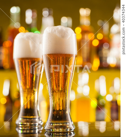 Jugs of beer served on bar counter Jugs of beer served on bar counter 40374344