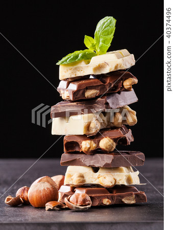 Pile of hazelnut chocolate on black background 40374496