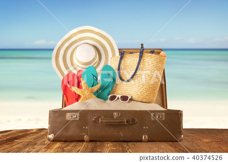 Travel concept with old suitcase on wooden planks 40374526