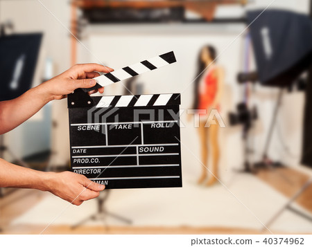 Man with film clapper in studio Man with film clapper in studio 40374962