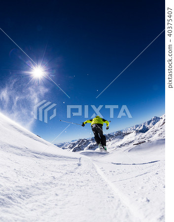 Alpine skier on piste, skiing downhill 40375407