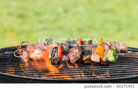 Vegetable and meat skewer on grill Vegetable and meat skewer on grill 40375431
