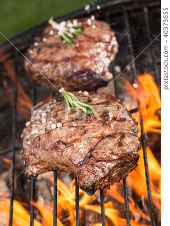 Beef steaks on grill 40375655