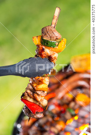 Vegetable and meat skewer on grill 40375775