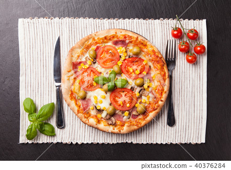Delicious fresh pizza served on black stone 40376284