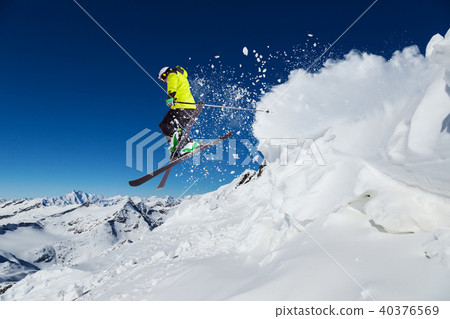Alpine skier on piste, skiing downhill 40376569