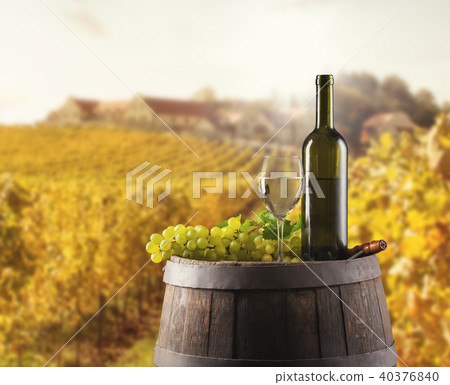 White wine bottle and glass on wodden keg 40376840