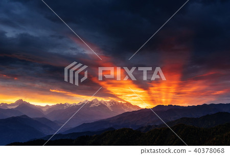 Sunset over snow-capped mountain peaks. 40378068