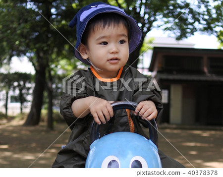 A 1 year old boy who plays with park play equipment 40378378