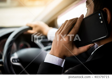 Attractive handsome young businessman using mobile smart phone i Attractive handsome young businessman using mobile smart phone i 40379715