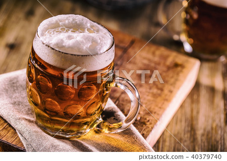 Close-up cold draft beer on wooden board Close-up cold draft beer on wooden board 40379740