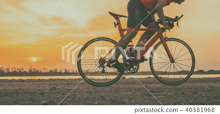 A cyclist riding a road bike on road in the moring 40381968