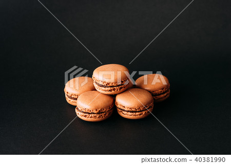 Close up of macaroons isolated on black background Close up of macaroons isolated on black background 40381990