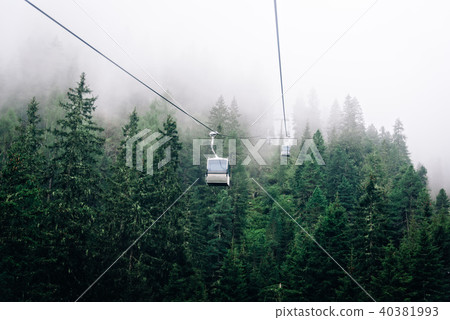 Cable car in mountain a foggy day Cable car in mountain a foggy day 40381993