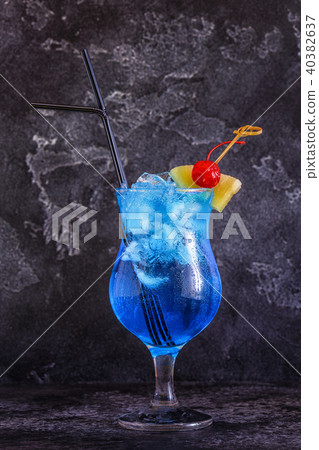 Blue Curacao cocktail decorated with fruit. 40382637