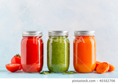 Orange/green/red colored smoothies / juice in jar 40382706