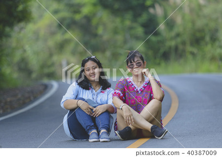 two generation of asian woman sitting on road two generation of asian woman sitting on road 40387009