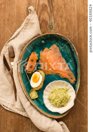 breakfast plate with smoked salmon and guakamole. 40389824