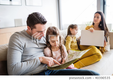 Young family with two children preparing for holidays. Young family with two children preparing for holidays. 40390535