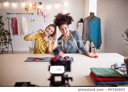 A camera and a slider with women in the background, startup business. A camera and a slider with women in the background, startup business. 40390803