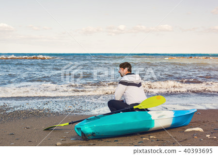 Man holding kayak oar against the sea 40393695