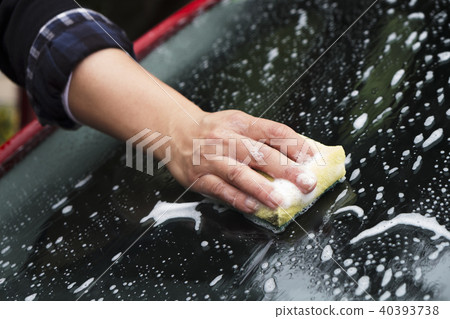 young woman washing a car 40393738