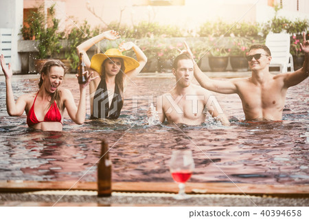 Young people having fun dancing in swimming pool. 40394658