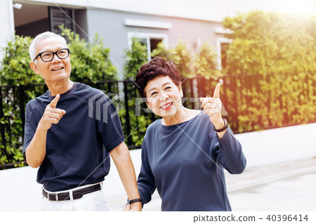Senior Asian couple walking in the park Senior Asian couple walking in the park 40396414