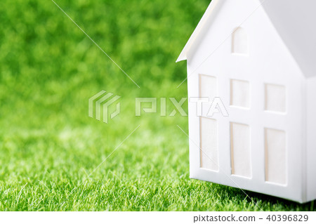 Model of white paper house on green grass Model of white paper house on green grass 40396829