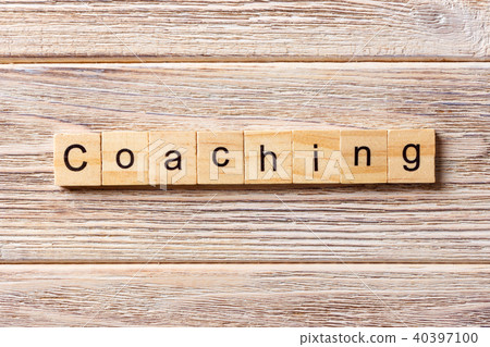 COACHING word written on wood block. COACHING word written on wood block. 40397100