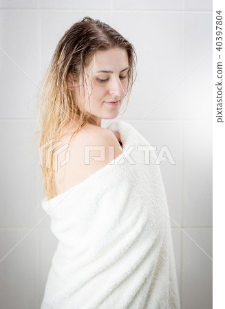 Beautiful young woman in white towel after having shower Beautiful young woman in white towel after having shower 40397804