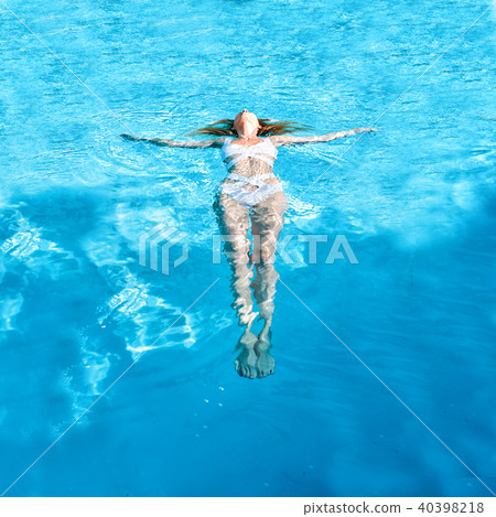 Beautiful girl swimming on back in water 40398218