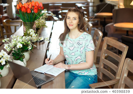 Young caucasian businesswoman in cafe. 40398839