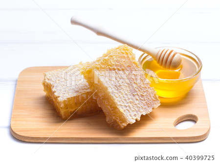 Honey with wooden honey dipper on wooden table 40399725