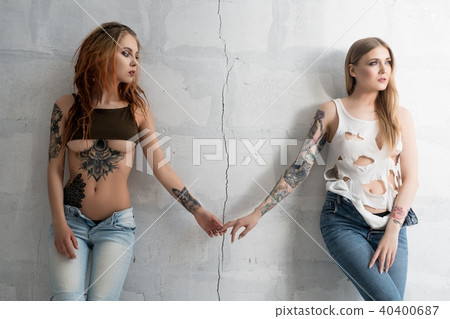 Sexy tattooed girls parting cropped view Sexy tattooed girls parting cropped view 40400687