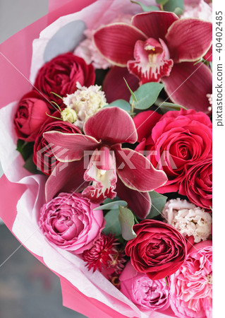Bright red bouquet of beautiful flowers on wooden table. Floristry concept. Spring colors. the work 40402485