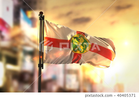 Alderney Flag Against City Blurred Background 40405371