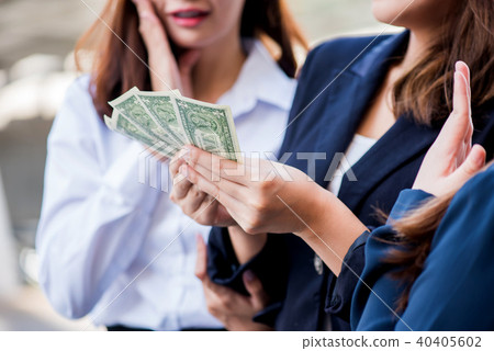 Asian businesswomen with colleague hold money Asian businesswomen with colleague hold money 40405602