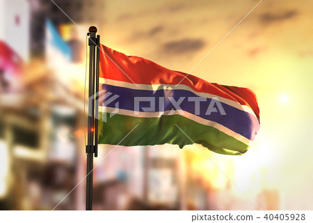 The Gambia Flag Against City Blurred Background 40405928