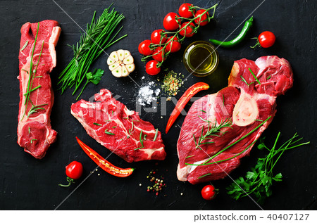 Raw meat steaks with cherry tomatoes, hot pepper 40407127