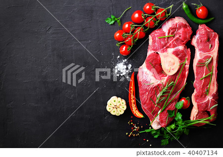 Raw meat steaks with cherry tomatoes, hot pepper Raw meat steaks with cherry tomatoes, hot pepper 40407134