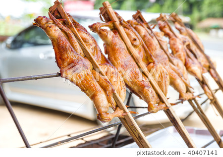 The whole roasted chicken in bamboo. The grilled The whole roasted chicken in bamboo. The grilled 40407141