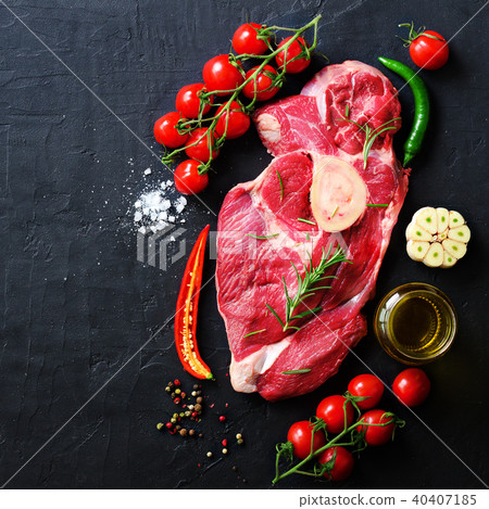 Raw fresh meat steak with cherry tomatoes, hot Raw fresh meat steak with cherry tomatoes, hot 40407185