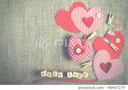 Red polka dot textile hearts on burlap. Free space 40407274