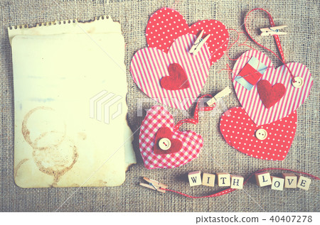 Red polka dot textile hearts on burlap. Free space 40407278
