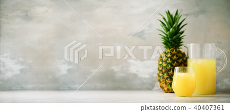Pineapple juice in glassware and whole pineapple 40407361