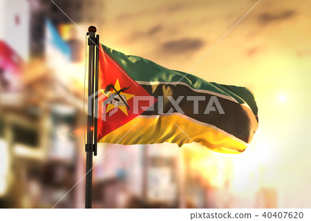 Mozambique Flag Against City Blurred Background Mozambique Flag Against City Blurred Background 40407620