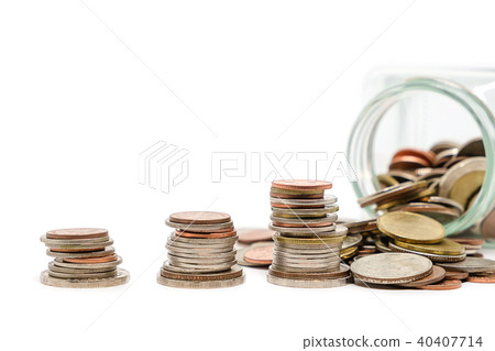 The glass jar of money and stack of coins 40407714