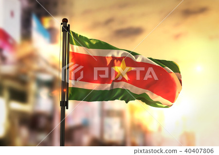 Suriname Flag Against City Blurred Background 40407806